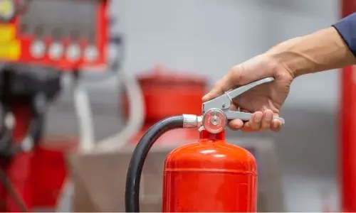 man holding fire extinguisher
